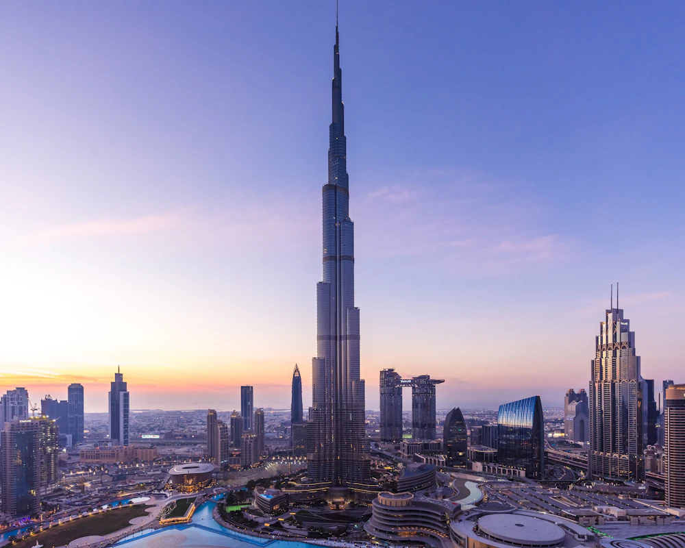Burj Khalifa rising above the Downtown Dubai skyline at sunset
